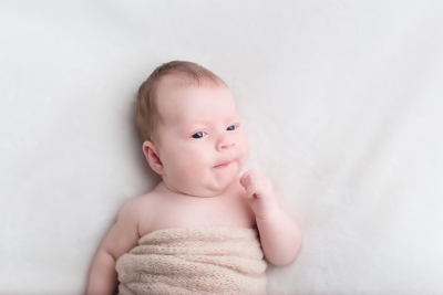 An Awake newborn looking close to the camera