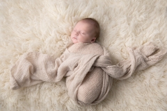 Sleeping baby on a nude blanket taken by Kimberly Kendall of Fairbanks, Alaska